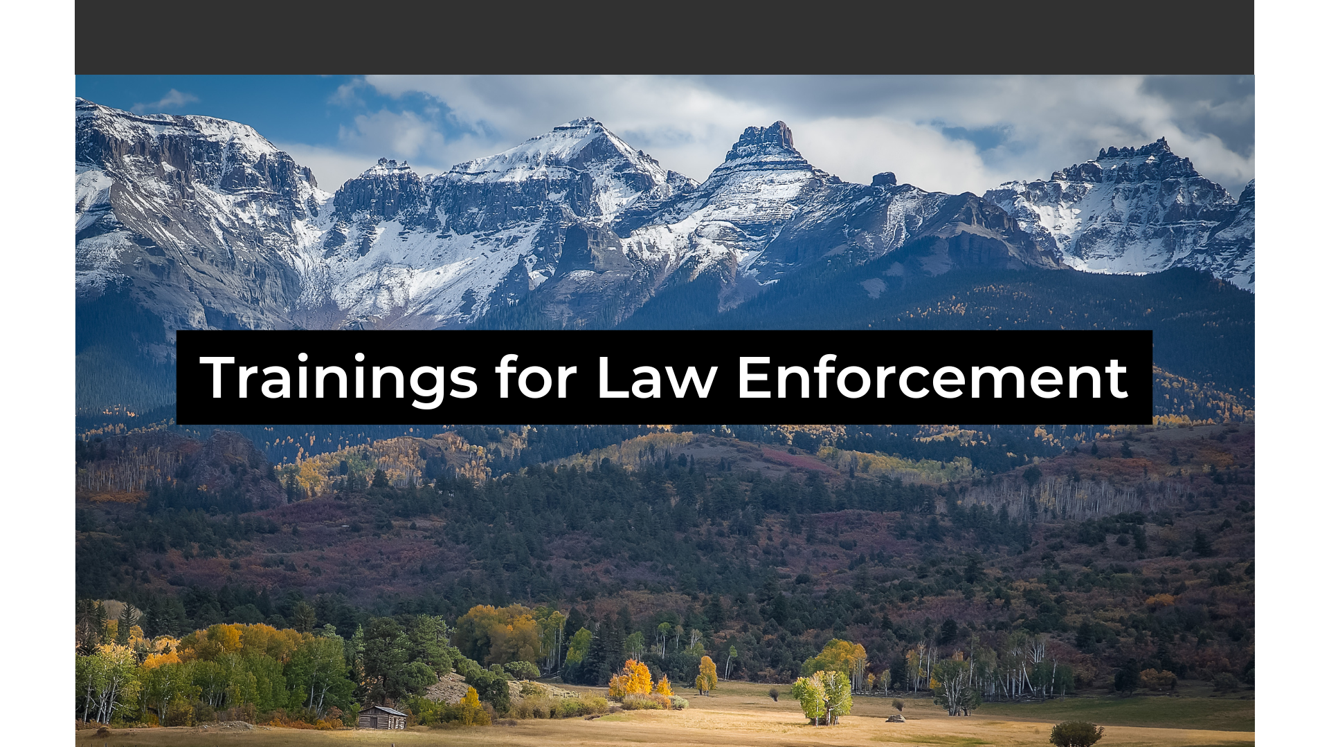 Snowcapped Rocky Mountains with a field below with the changing fall colors with words saying Training for Law Enforcement