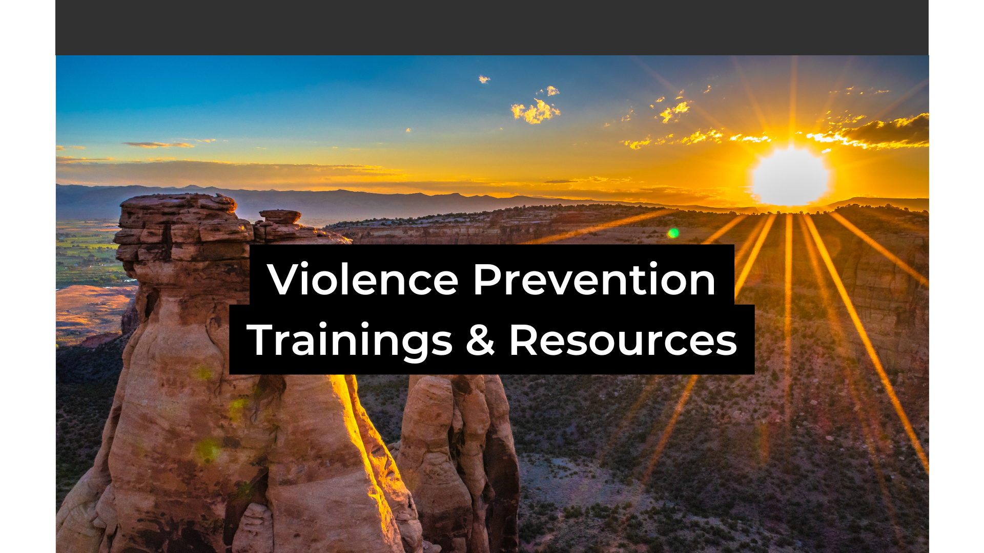 Colorado National Monument in the background at sunrise with the words Violence Prevention Trainings & Resources